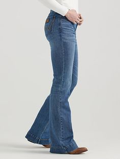 THE TROUSER: THE ULTIMATE IN WOMEN'S RETRO® JEANS Like all Wrangler Retro® jeans, our Mae wide-leg trouser jean is marked by its Western authenticity, making it a go-to style for cowgirls everywhere. With its contour waist and mid-rise fit, these women's trouser jeans are made to fit comfortably while they flatter all your curves. With more room at the knee and a gradual opening down the leg, the Mae wide-leg trouser gives you the room you need to stay active and in style. Women Wrangler Jeans, Womens Trouser Jeans, Cowgirl Jeans, Destructed Jeans, Retro Jeans, Loose Fit Jeans, Stay Active, Wrangler Jeans, Dark Wash Denim