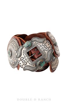 A COLLECTOR CONCHO BELT BY LEGENDARY NAVAJO ARTISAN, THE LATE KIRK SMITH. The ornate sterling silver frame buckle is affixed to a brown leather belt that features alternating oval conchos and beautiful sterling silver butterfly spacer conchos; all adorned with smooth stones of gorgeous green turquoise. Absolutely stunning statement piece, this is one for the serious collector. Made in the USA. Kirk came from a well-known family of silversmiths. He began working with silver as a young boy in the Vintage Adjustable Turquoise Belt, Adjustable Vintage Turquoise Belt, Adjustable Turquoise Vintage Belt, Concho Belts, Collar Tips, Concho Belt, Cashmere Accessories, Stocking Gifts, Belt Jewelry