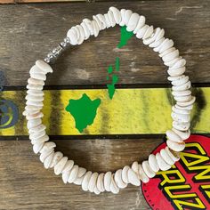 a bracelet made out of white beads with a map of africa on it