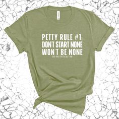 Make a bold statement with our "Petty Rule #1: Don't Start None, Won't Be None" T-shirt. Perfect for those who believe in setting boundaries and keeping the peace, this tee combines attitude with comfort. Wear it, mean it, and let everyone know you play by your own rules. Runs true to size 100% combed ring-spun cotton 4.3-ounce jersey knit fabric Side-seamed NEXT LEVEL APPAREL COTTON CREW - 3600 We print each item on demand. Please review the FAQs for our current production times. Once your order has been printed, it will be shipped with online tracking and text/email notifications. God Ain't Petty, but I am ™️ Green Summer Shirt With Slogan, Funny Green Tops With Letter Print, Funny Green Top With Letter Print, Green Short Sleeve Shirt With Funny Text, Green Graphic Tee With Funny Text, Green Funny Tops With Text, Casual Green Tops With Funny Text, Green Casual Top With Funny Text, Funny Green T-shirt With Slogan