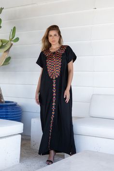 A bohemian flash caftan made of light mesh of linen and poly, the fabric is unique in that it's very flowy and not the usual feel and touch of linen. This Kaftan is ideal to wear for any casual occasion. Whether taking a trip down the shopping lane, or home-based kitty parties, or about anything else, wearing this dress will make you feel classy and comfortable. Fabric : 50% Linen, 50% Polyester. Please note that the fabric on this Kaftan has some weight to it and is meant to give off that crumb Traditional Maxi Dress With Multicolor Embroidery, Traditional Multicolor Embroidered Maxi Dress, Black Abaya With Floral Embroidery, Black Floral Embroidered Beach Maxi Dress, Traditional Black V-neck Abaya, Black Bohemian Embroidered Abaya, Bohemian Style Festival Abaya Floor-length, Bohemian Floor-length Abaya For Festival, Bohemian Festival Floor-length Abaya