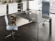 an office with a glass desk and chairs