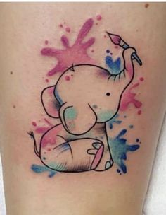 an elephant with paint splattered on it's leg