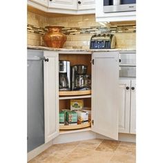 an open cabinet in the corner of a kitchen