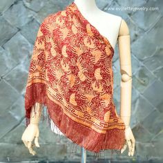 Name : Kirana Silk Scarf Fabric : 100% soft silk Size : Large (175x90 cm) Colour : Red , Gold Motif : Garden Code : SCL-DR-23Y-GD KIRANA SILK SCARF Kirana Silk Scarf is an artisan scarf (shawl) produced by La Maison D'Evolette - Elvinna Brion. it is a genuine silk fabric, displaying Batik pattern that preserve the rich cultural and multi-faceted heritage of Indonesia.  The technic we use is combining between "Batik Tulis" (Handwritten/ Handdrawn Batik) and "Batik Tjap" (Stamped Batik). Silk Silk is a natural fiber produced by silkworms. It is made from the cocoons spun by the larvae of the silk moth, known scientifically as "Bombyx mori". The silk production process begins with the cultivation of silkworms and ends with the extraction of silk threads from the cocoons. The result of silk fa Silk Scarves With Traditional Patterns, Silk Scarves With Traditional Patterns And Drape, Bohemian Silk Scarf With Batik Print, Silk Shawl Scarves For Beach, Silk Shawl Scarf For The Beach, Silk Shawl Scarf For Beach, Red Silk Bohemian Pashmina Shawl, Patterned Silk Scarf Shawl, Patterned Silk Shawl Scarf