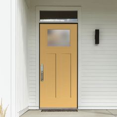 a yellow front door on a white house