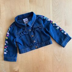 Nwot Nanette Lepore Kids Denim Jacket Has Floral Embroidery Down Sleeves, And A Ruffled Front And Back Seam . Cotton. In New Condition. See Close Up Picture For Details Spring Cotton Outerwear For Playtime, Blue Cotton Denim Jacket For Playtime, Cute Long Sleeve Denim Jacket For Spring, Cute Fitted Long Sleeve Denim Jacket, Fitted Long Sleeve Cute Denim Jacket, Cute Denim Blue Cotton Outerwear, Spring Denim Jacket For Playtime, Cute Medium Wash Cotton Outerwear, Cute Outerwear For Spring Playtime