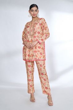 Pink short tunic style top with multi colored floret prints with embroidered neckline and placet. Comes with coordinating printed pant. - Aza Fashions Multicolor Digital Print Lawn Suit For Work, Floral Print Long Sleeve Lawn Suit For Work, Multicolor Cotton Lawn Suit For Workwear, Workwear Floral Print Lawn Suit, Spring Workwear Lawn Suit With Printed Motifs, Floral Print Cotton Pant Set, Floral Print Cotton Sets For Workwear, Unstitched Summer Sets For Workwear, Cotton Floral Print Sets With Straight Pants