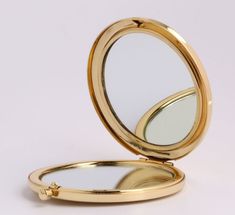 an open compact mirror sitting on top of a table