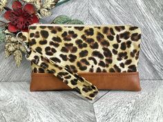 "An exterior zipper pocket can be added for an additional cost. Please message me prior to purchasing this listing. This cute wristlet wallet is the perfect go to alternative to our everyday handbags! It will hold all your necessities including credit cards, ID and your smartphone. Super convenient for the mom on the go!! This sleek and contemporary wristlet clutch was designed using a leopard print fabric. It has a faux tan leather base and a detachable strap. The well organized interior is a s Adjustable Brown Pouch Wristlet, Gift Wristlet Clutch With Wrist Strap, Gift Clutch Wristlet With Wrist Strap, Gift Wristlet With Wrist Strap, Brown Wristlet With Zipper Pouch For Gift, Brown Wristlet With Zipper Pouch As Gift, Everyday Handbags, Chapstick Lip Balm, Leopard Print Fabric