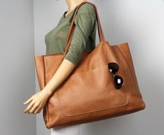 "Soft, flexible camel grain leather tote bag for books or for summer weekends. A large, camel leather bag can be easily taken to the beach. This wonderful bag has a lot of space. This is a really, really big bag. Front of bag features an exterior pocket for quick-access to your keys or phone. Large interior pocket measures approximately 15\" wide by 12\" long Wery useful , gorgeous everyday bag for all seasons! Height: 39 cm / 15.4\" Max width at the top: 61 cm / 24\" Width at the base: 51 cm / Camel Leather Bag, Big Shoulder Bag, Leather Gifts For Her, Tan Leather Handbags, Leather Shopper Bag, Soft Leather Tote, Everyday Handbag, Oversized Tote Bag, Oversized Tote