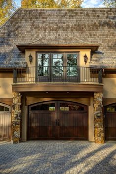 a large house with two garage doors and windows