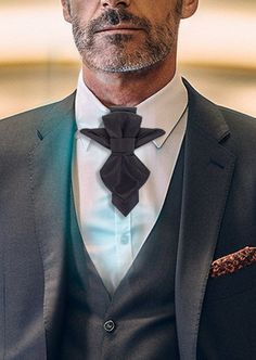 "Introducing the \"Vertex\" - a distinctive, handcrafted, luxury bow tie, exclusively designed for the discerning gentleman seeking to make a timeless statement. Meticulously crafted with a keen eye for detail, this black masterpiece boasts an original, striking design. Characterized by its sharp, pointed corners and tops, the Vertex exudes an air of sophistication, making it an ideal accessory for formal occasions. Its refined linear texture adds an extra touch of elegance, ensuring it stands o Dapper Suit And Tie Accessories For Father's Day, Party Suit And Tie Accessories For Father's Day, Elegant Fitted Bow As Gift, Elegant Fitted Bow For Gift, Elegant Party Ties For Father's Day, Dapper Bow Tie For Black-tie Events, Classic Bow Tie For Suit Accessories As Gift, Formal Ties With Decorative Bow For Black-tie Events, Elegant Bow Tie For Father's Day Party