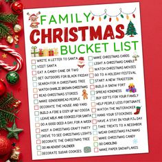 a family christmas bucket list with ornaments and candy canes on a red table top