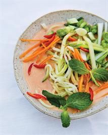 a white bowl filled with vegetables on top of a table