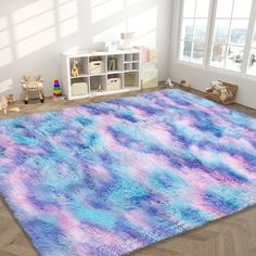 an area rug with blue, pink and purple designs on it in a child's room