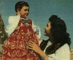 an old photo of a woman holding a child