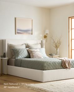 a bedroom with a large bed and white walls