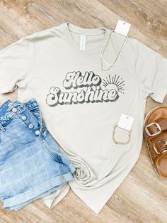 Hello Sunshine! This relaxed fit tee featured short sleeves, unisex fit with a crew neck and straight hem. Graphic designed in the US. 100% COTTON Sunshine Graphic, Sunshine Design, Camp Vibes, Hello Sunshine, Graphic Tee, Graphic T Shirt, Graphic Tees, Short Sleeves, Relaxed Fit