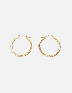 The perfect organic hoops for everyday, available in three sizes. These are meant to be lived in, with a different size available for every occasion. We love the subtle statement of the oversized version with its unique texture and shine. Solid 14k yellow gold Small is 1.25in x 1.25in Medium is 1.5in x 1.75in Large is 2in x 2.5in All pieces are handmade to order in Brooklyn