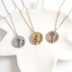 Personalized coin birth flower with name necklace, this pendant makes a great birthday gift for daughter, mom and grandma and also for your best friends. You can customize the front of the pendant with the birth flower  of your choice and a name. The disc necklace is made of stainless steel and it measures 0.8" / 18 mm available in four colors: gold, rose gold, black and silver. The pendant comes with and adjustable stainless steel (18-20") chain that will fit just perfect on any body type. This keepsake can be purchased with or without a birthstone and it can be engraved on the front only or to make it even more personal  we can engrave one of the following options on the back side. OPTION 1: "NO engraving on back" We will not engrave anything on the back, the back will be blank. OPTION 1 Birth Flower With Name, Birth Month Flower Bouquet, Grandma Jewelry, Mom Necklace Personalized, Jewelry Name, Grandma Necklace, Mama Necklace, Mom And Grandma, Birth Month Flowers