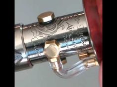 a close up view of the inside of a silver and gold revolver with its barrel pointing upward