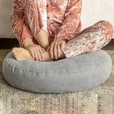 a woman sitting on top of a bean bag chair