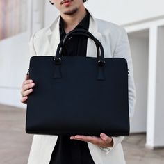 Invest in a timeless piece of office style with this Leather Laptop Briefcase. Crafted from genuine leather, this unisex leather laptop bag is perfect for anyone who needs to look professional and wants to make a lasting impression. It features an interior with 2 compartments -- a small one with a zipper and another larger one to store all your documents. Plus, it can hold a laptop up to 15 inches, including a MacBook, so you can keep your laptop safe and secure when you're on the go.  ◆Product Name: Leather Briefcase ◆Materials: Full Grain Cowhide Leather, Brass Closure, Fabric Lining, Genuine Leather In Black Color ◆Dimensions: 15.7 X 11.8 X 3.9  ◆Perfect For 15 Inch Laptop For added convenience, this briefcase comes with a leather shoulder strap. This means you can easily transition fro Macbook Pro Bag, Gifts For Friend, Teacher Wardrobe, Laptop Briefcase, Leather Laptop Bag, Friend Gifts, Dad Gifts, Wet Bag, Gifts For Boss