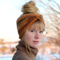 a woman with blonde hair wearing a knitted headband and looking off into the distance