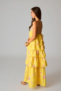 If sunshine were a dress, this one would be it! Her straps cross in the back with a tie to adjust to your comfort. The v-neck and ruffled tiers make her fun and flirty! This Callie Maxi is a must have for all this seasons events. Product Details: Fit: The Callie fits true to size. Length: Maxi length. The small measures to be 41.5" from shoulder to hem. Bust: Accommodates most bust sizes. Not bra friendly. Waist: Fitted- elastic allows some stretch. Fabric: Fabric contains no stretch. Material: Yellow Ruffled Maxi Sundress, Yellow Tiered Skirt Maxi Dress, Casual Yellow Tiered Maxi Dress, Yellow A-line Maxi Dress With Ruffles, Yellow V-neck Floral Beach Dress, Getaway Dress, Womens Boho Dresses, Dress Design Patterns, Cute Lazy Outfits