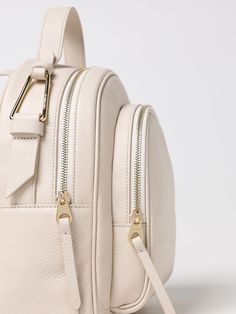 Find COCCINELLE Backpack on Editorialist. This Coccinelle backpack features a top handle, adjustable straps, and a zip closure. It can be carried on the back, worn on the shoulder, or hand carried. The bag has a logo detail and is made of leather.