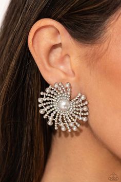 Shimmery strands of silver spin out from a white pearly center, creating an exaggerated firework-like display at the ear. An explosion of dainty iridescent rhinestones, dainty white pearls, and white rhinestones lines the swirls and curves of the shimmery display, creating an eye-catching display. Earring attaches to a standard post fitting. Due to its prismatic palette, color may vary. Sold as one pair of post earrings. Silver Strand, Latest Jewellery Trends, Spin Out, Palette Color, December 2023, Party Earrings, Paparazzi Accessories, Latest Jewellery, White Rhinestone