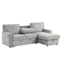 a gray couch with pillows on it and a footstool in front of it