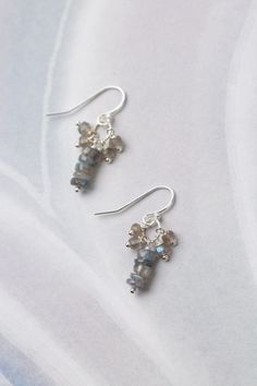 These sweet and simple cluster earrings are perfect for pairing with other items from the Mystic Collection. Sterling Silver (Lead & Nickel Free) Labradorite 1.25" with sterling silver ear wires We hand select our natural materials, thus there may be slight variations in color and/or size that will not detract from the overall aesthetic. Our unique handcrafted designer jewelry for women is made in America, each design created individually in our personal design studio in Floyd, VA USA Nickel-free Labradorite Earrings For Jewelry Making, Gift Cluster Earrings With Sterling Silver Ear Wire, Dainty Sterling Silver Cluster Drop Earrings, Floyd Va, Silver Gold Earrings, Silver Gold Necklace, Gemstone Jewellery Design, The Mystic, Pearl Gemstone