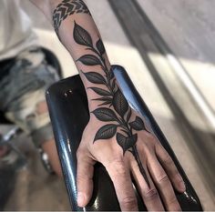 a person's hand with a tattoo on it