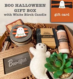 the boo boo halloween gift box with white birch candle, candles and other items in it