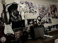 a room filled with guitars and pictures on the wall next to a stuffed animal toy