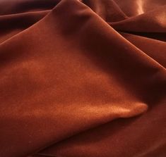 a close up view of a brown fabric with some very thin folds on the side