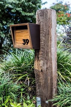 a wooden post with a mailbox attached to it