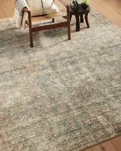 a living room with a couch, chair and rug