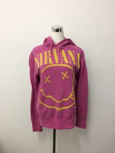 "Vintage Rare 90s Nirvana Smiley Hoodie Sweatshirt American Grunge Rock Band Kurt Cobain Pullover Jumper Hooded Official Nirvana Merchandise 1992 Made In USA . BRAND: CHESAR . SIZE ON TAG: M . COMPOSITION: 50% Cotton 50% Polyester Made In USA . Please compare the measurement with your garment. . ACTUAL SIZE MEASUREMENT:- 1.Sleeve length: 25\" inches 2.Shoulder to Shoulder: 19\" inches 3.Chest: 20\" inches 4.Front Length: 25.5\" inches 5.Hem: 17\" inches 6.Sleeve cuff: 4\" inches *All measurement 90s Hoodie Tops For Winter, Concert Hoodie For Fall With Long Sleeves, Fall Concert Long Sleeve Hoodie, Long Sleeve Hoodie For Fall Concerts, 90s Hooded Sweatshirt With Graphic Print, 90s Hooded Graphic Print Sweatshirt, Graphic Print Hooded Top For Concert, Hooded Graphic Print Top For Concert, Graphic Print Hoodie For Alternative Fashion In Fall