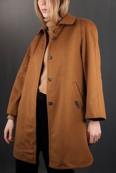 Beautiful Loden coat in camel beige by Dolomiten, made from 95% virgin wool and 5% nylon in Italy. The lining is made from viscose. In very good vintage condition, signs of wear are minor (only two small stains in the inside lining). Size M for women. The model is 175cm tall, usually also wearing a size M.  Shoulders ca 51cm (continuous sleeves) Chest 48cm Sleeve ca. 51cm (continuous sleeves)  Length 84cm ... Discount for multiple items, applies automatically at check-out:  3 or 4 items: 15% Off Classic Brown Wool Coat For Cold Weather, Classic Cognac Outerwear For Work, Brown Long Wool Coat For Cold Weather, Classic Camel Winter Outerwear, Classic Fall Outerwear In Cognac, Camel Wool Coat For Fall, Cognac Outerwear For Work In Fall, Cognac Long Sleeve Outerwear For Work, Cognac Colored Outerwear For Work In Fall