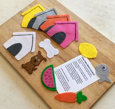 felt cutouts are laid out on a cutting board