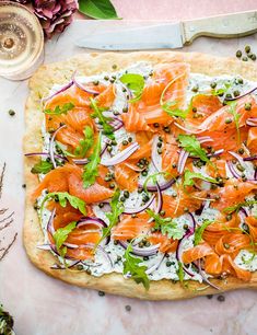 a pizza topped with lots of toppings on top of a table