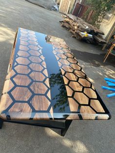 a table made out of wood and metal with blue paint on the top is shown