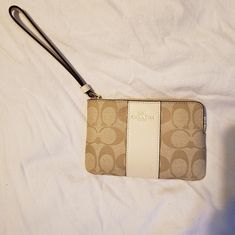 Brand New Coach Brand Wristlet. Length: 6.25" Height: 4.0" Width: 0.5" Color Gold/Lt Khaki/Chalk Signature Costed Canvas And Cross Grain Leather Chic Cream Wristlet For Everyday, Chic Cream Wristlet For Daily Use, Chic Beige Pouch Wristlet, Beige Rectangular Coach Clutch, Chic White Wristlet With Zipper Closure, Cream Clutch Wristlet With Wrist Strap, Chic Cream Pouch Wristlet, Cream Wristlet Clutch With Wrist Strap, Cream Rectangular Wristlet With Zipper Pouch