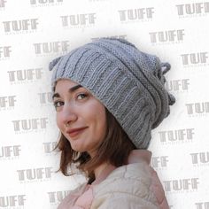 a woman wearing a gray knitted hat