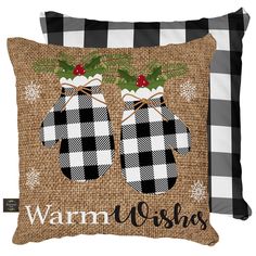 two pillows with christmas decorations on them and the words warm wishes written in black ink