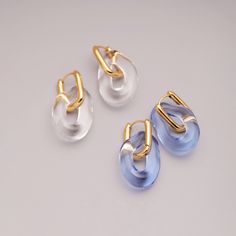 Introducing our Hand-Blown Glass Organic Hoop Earrings – a fusion of nature's grace and modern luxury. Crafted with care, these earrings feature: - Organic Shape for unique elegance.- Gold Accent for a touch of opulence.- Streamlined Forms for modern sophistication.- Transparency and Translucency for captivating light play. Sold as pair.Length: 3.5cm Hoops: 22k gold plated vermeil. Elevate your style with these earrings that celebrate the beauty of nature and contemporary design. Order now and e Luxury Blue Glass Jewelry, Candy Jewelry, Glass Drop Earrings, Contemporary Earrings, Glass Rings, Bling Rings, Gold Accent, Modern Earrings, Gold Drop Earrings