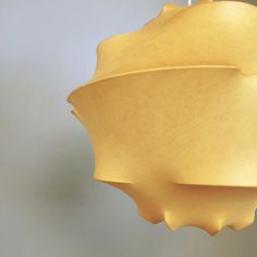 a yellow light fixture hanging from a ceiling